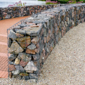 a modern urban park environmental object, gabion fence wall from steel mesh with stones